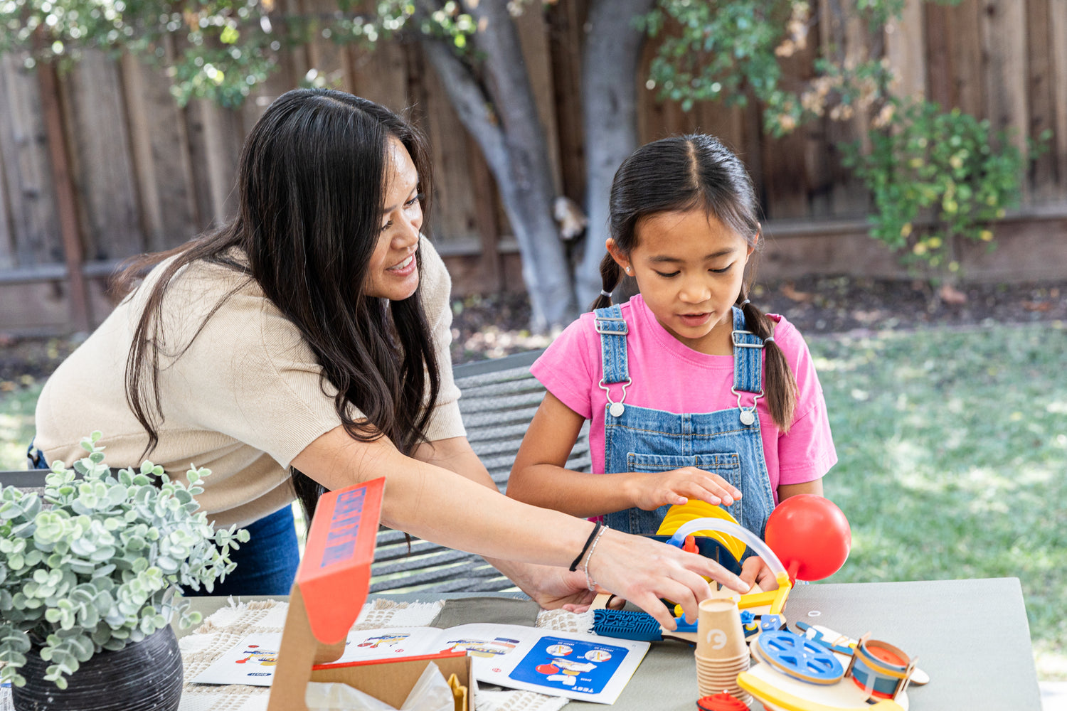 Photo of a Mom and Daughter Assembling a Build Box