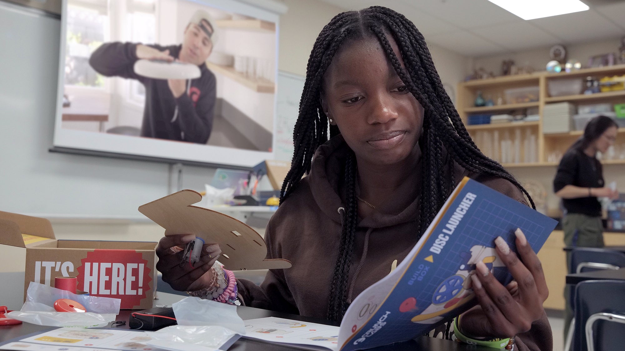 Photo of Young African American Woman with a Build Box in her Classroom